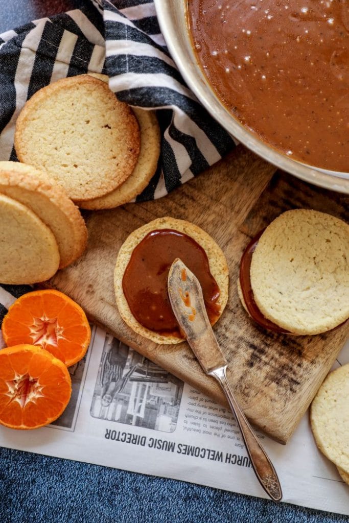 Keto shortbread cookie that has caramel being spread onto it