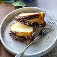 Two slices of keto samoa bundt cake on a plate with a fork.