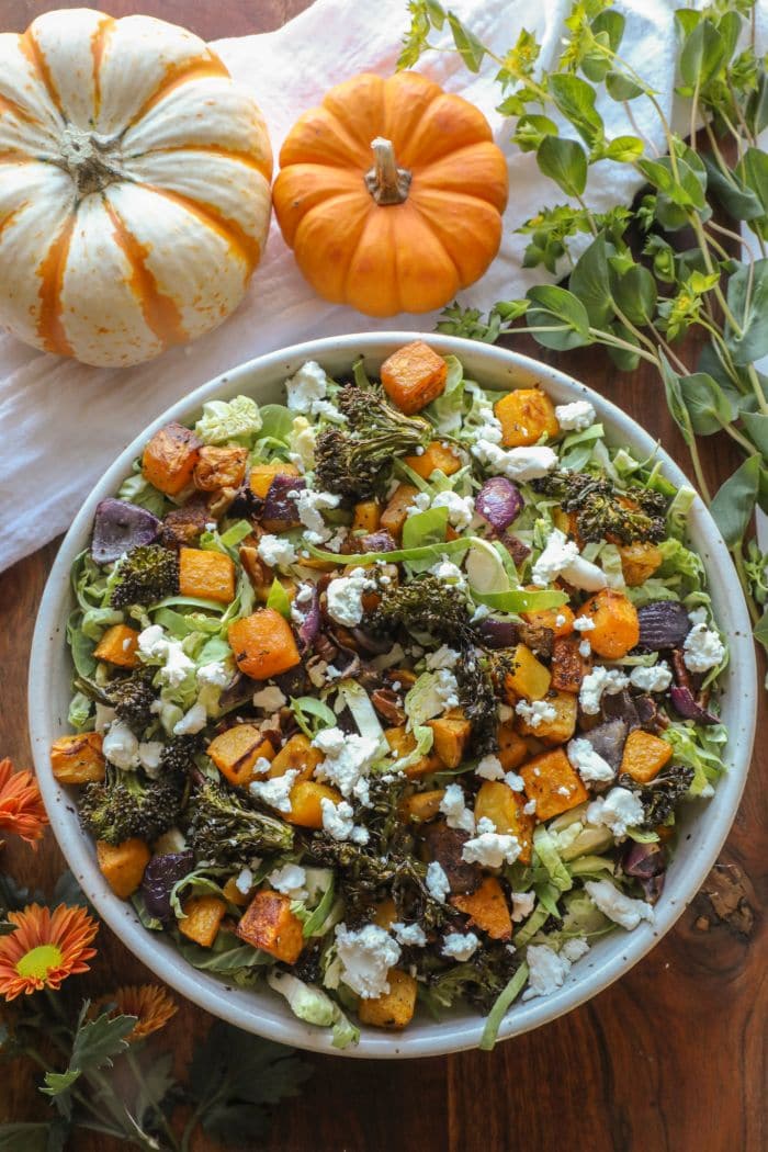 Shredded Brussel Sprouts and Roasted Vegetable Salad in a large white bowl