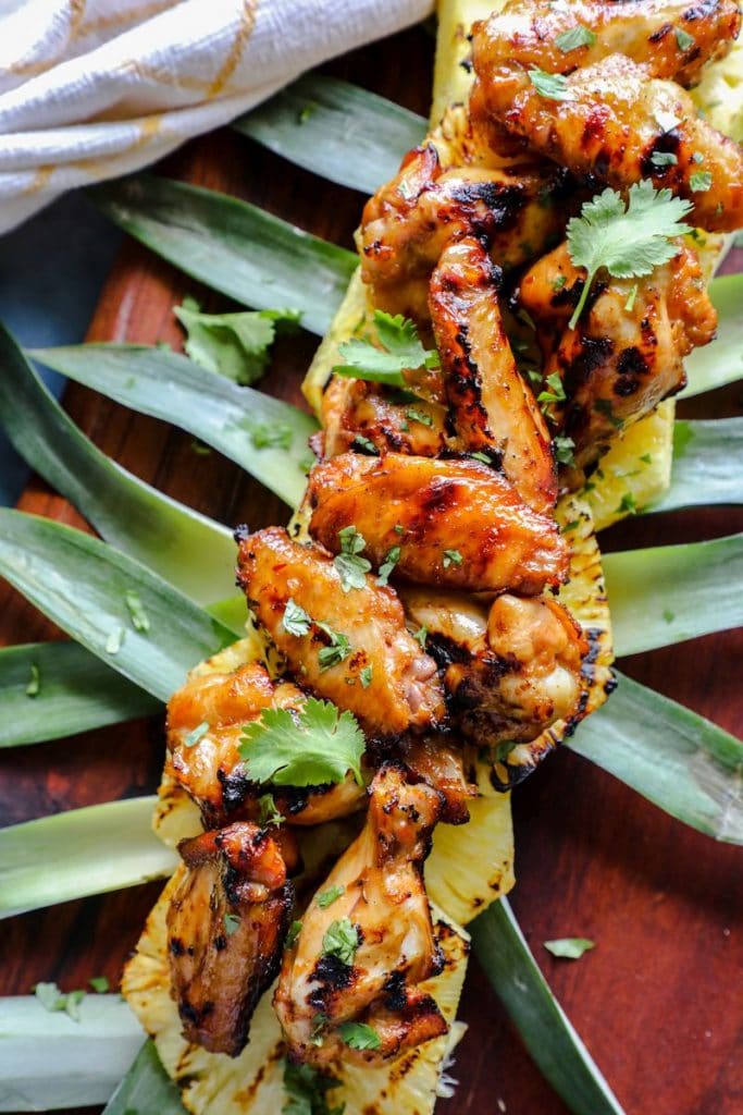 Hot Honey Hawaiian Wings on grilled pineapple