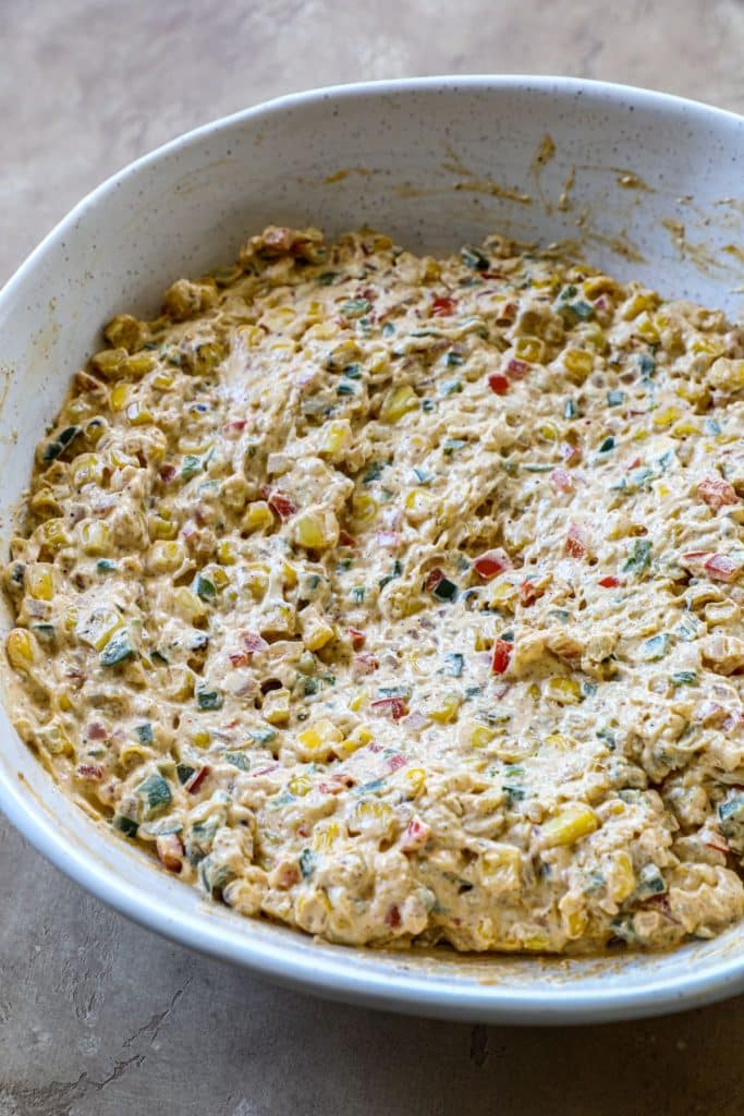 Fiesta dip ingredients mixed and combined together in a bowl.